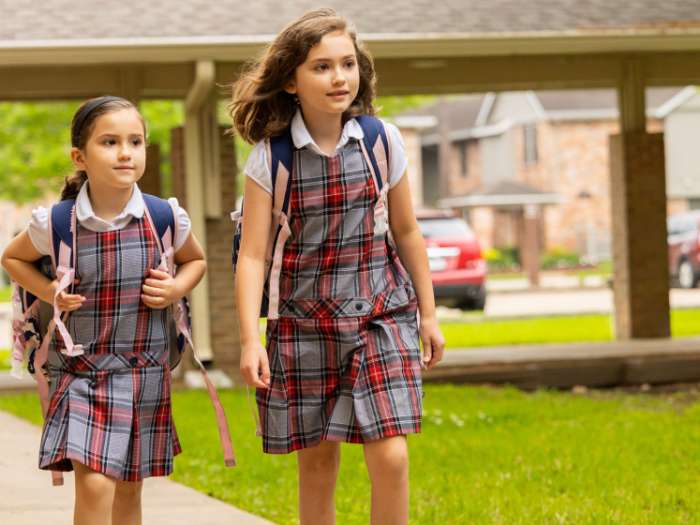 2 female students walking outside