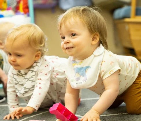 two infants with blocks