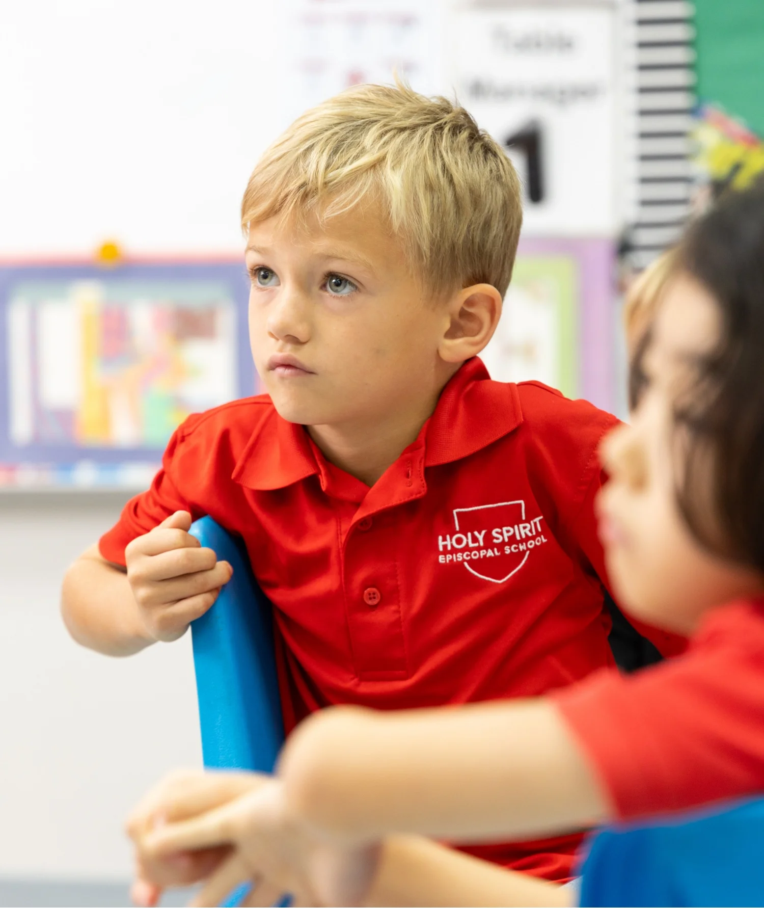 student in classroom looking at teacher