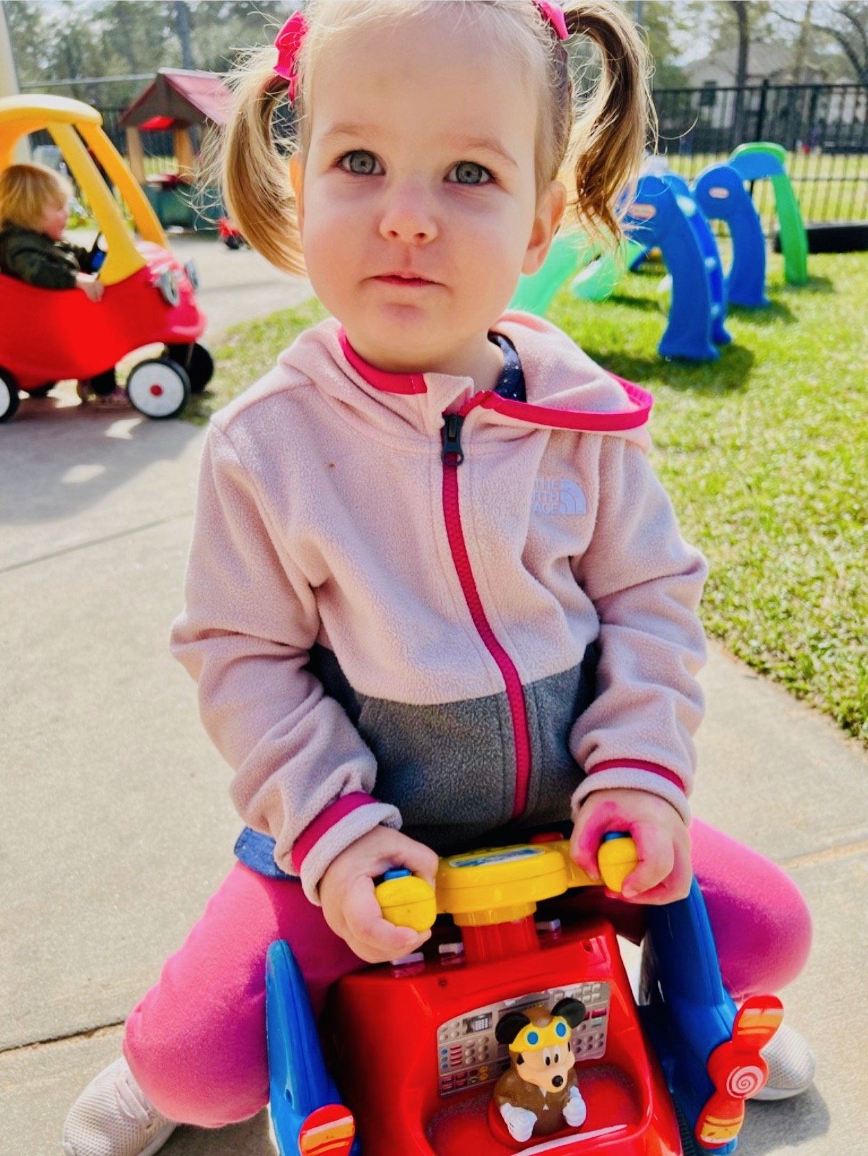 Toddler student riding on a toy truck