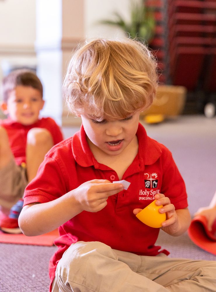 Primary school student playing with a toy