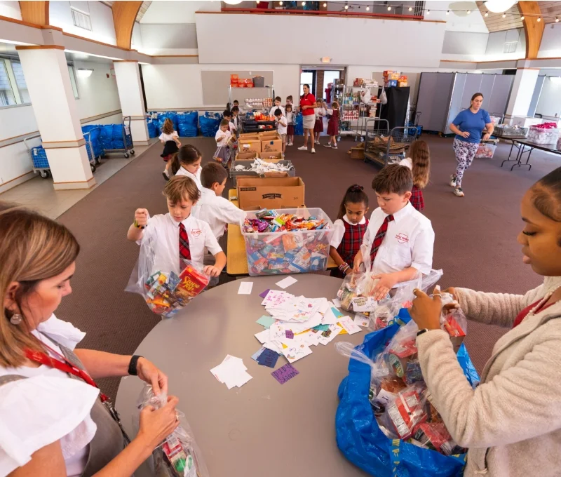 students and teachers filling bags for food pantry