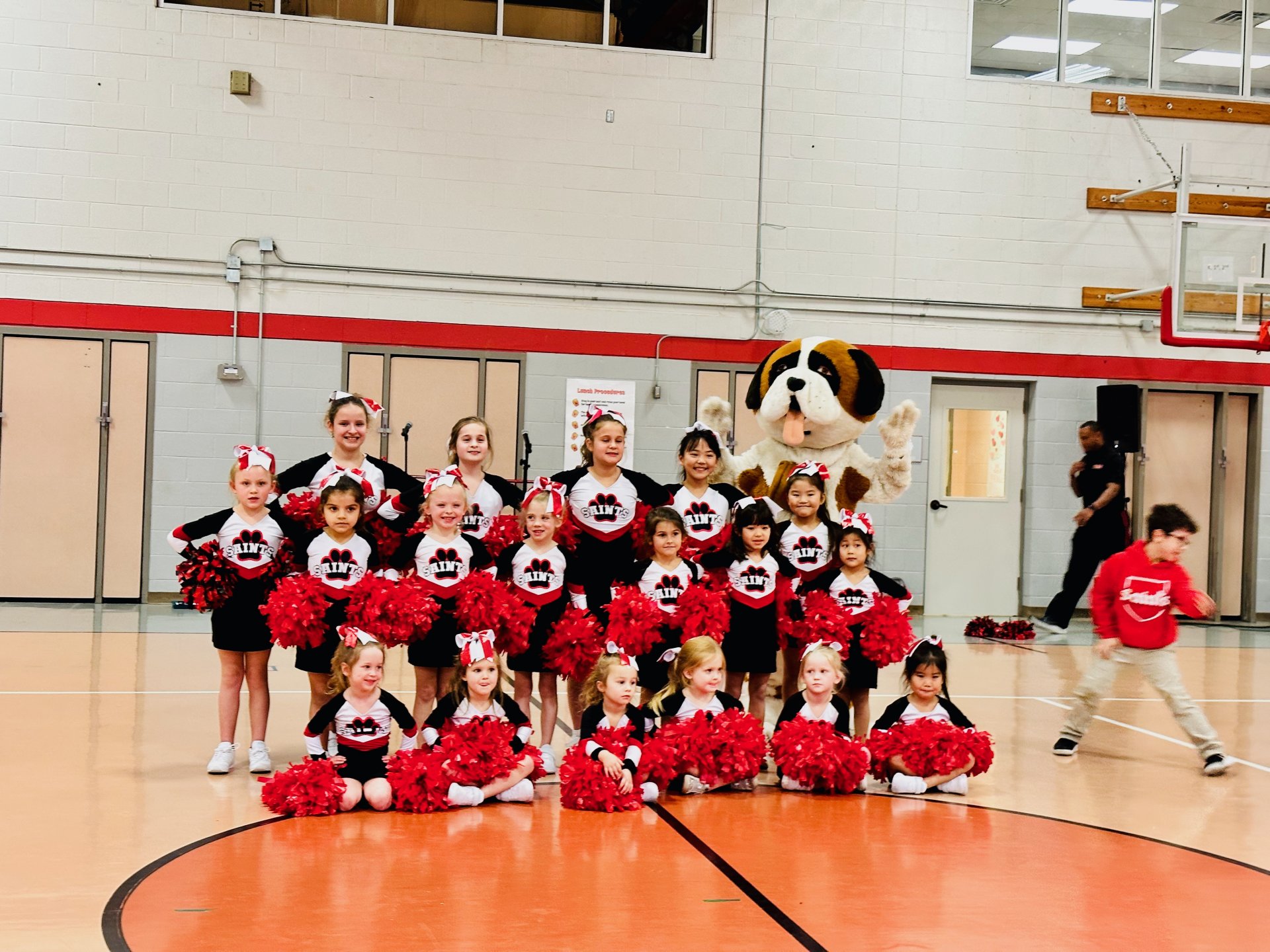 Group photo of school cheerleaders and mascot 