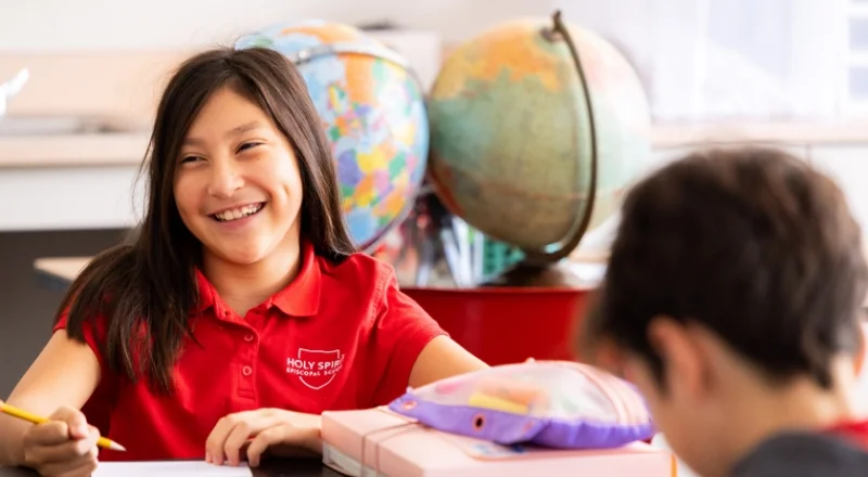 student smiling and working